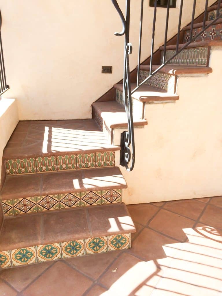 Stairs with Lincoln treads and tiles and decorative Spanish tiles in greens and reds on the risers