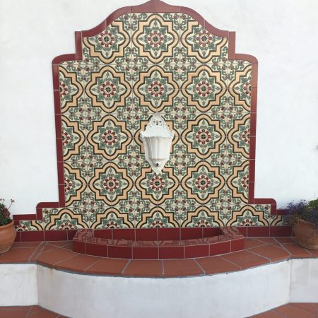 Spanish tile fountain backsplash with red trim